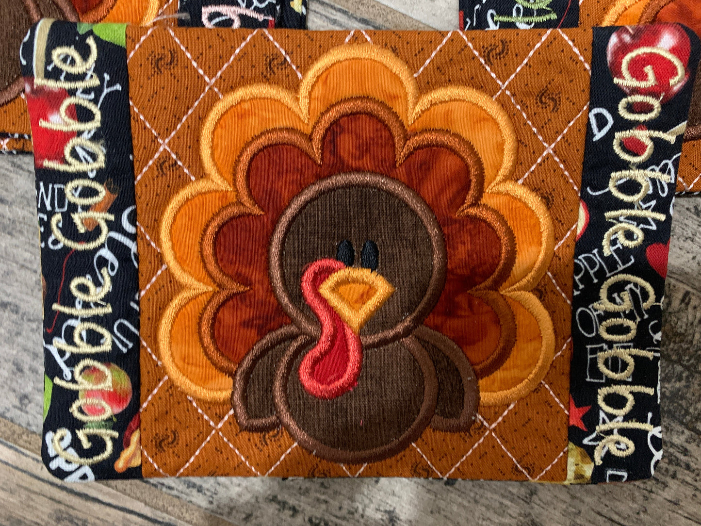 Decorative coaster with a turkey design and 'Gobble Gobble' text on edges.
